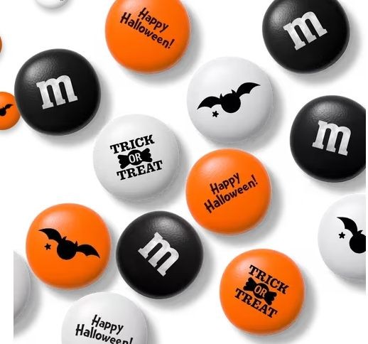 Halloween-themed candies with bat and text designs in black, white, and orange.