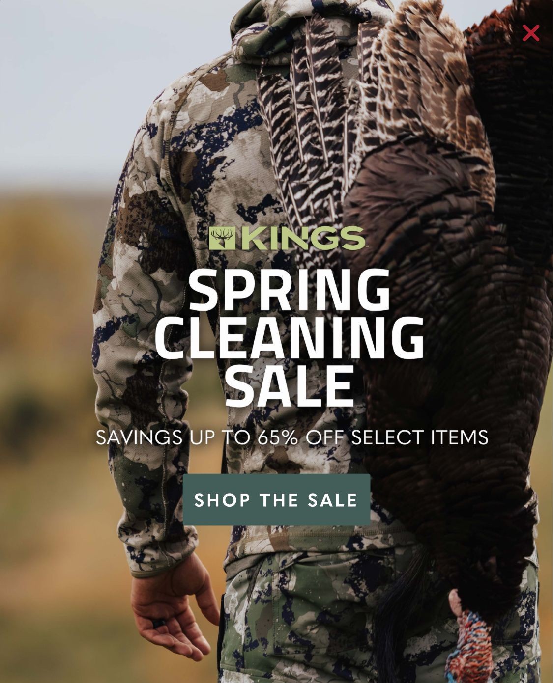 Person in camouflage with game over shoulder promoting spring cleaning sale with up to 65% off.