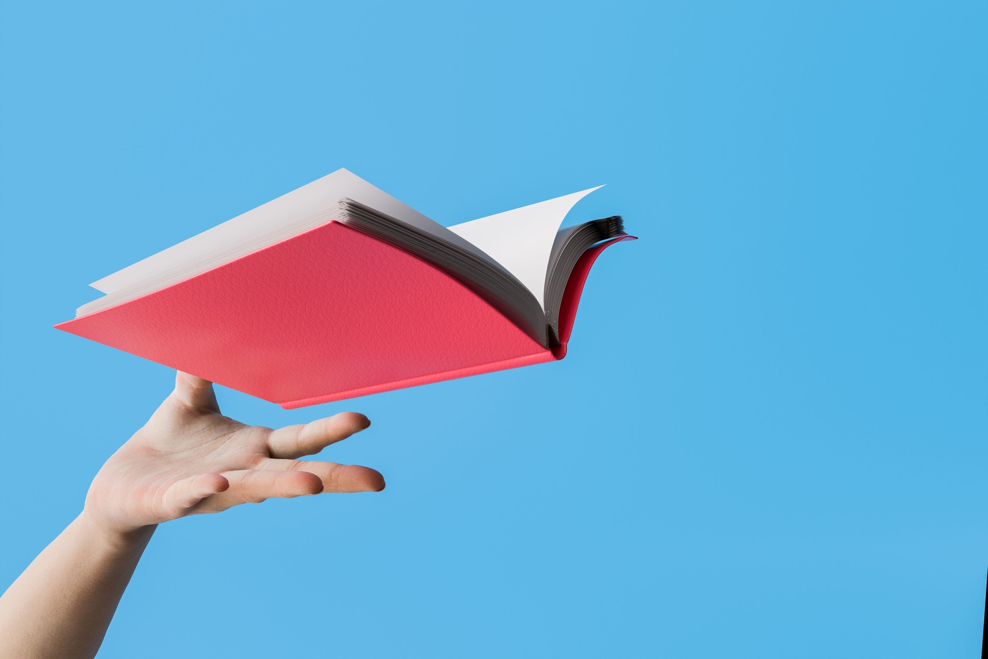 Hand Launching Red Book Against Blue Background with Copy Space